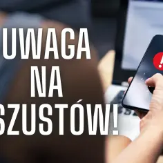 Dłoń trzymająca smartfon z czerwonym wykrzyknikiem, obok laptop. Napis: UWAGA NA OSZUSTÓW!