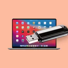Pendrive podłączony do ekranu MacBooka z widocznymi ikonami aplikacji.